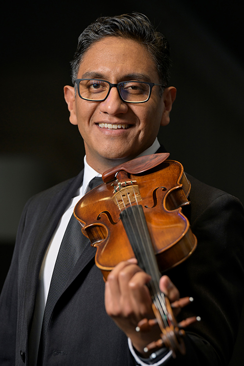 Photo of Adrian with a violin