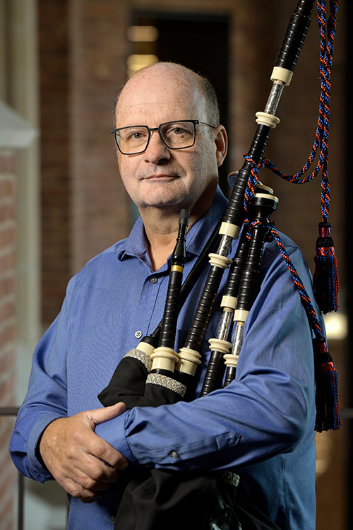 Photo of Iain with bagpipes