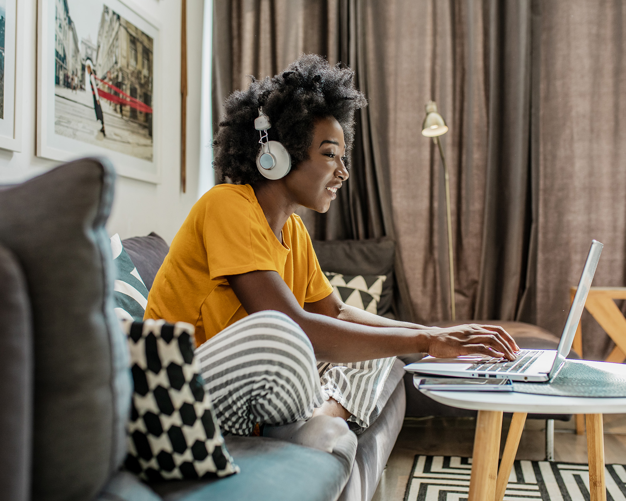 Woman on couch using a computer