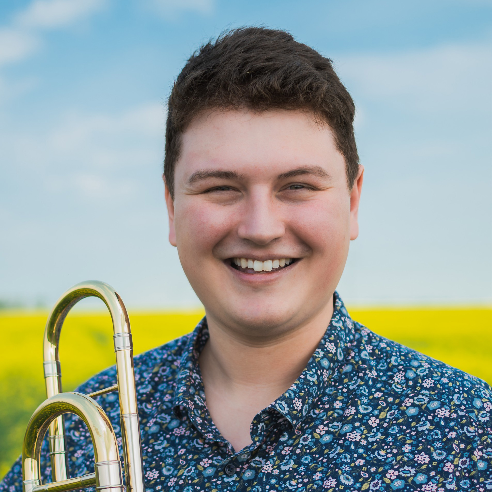 Man posing for camera in wheat field